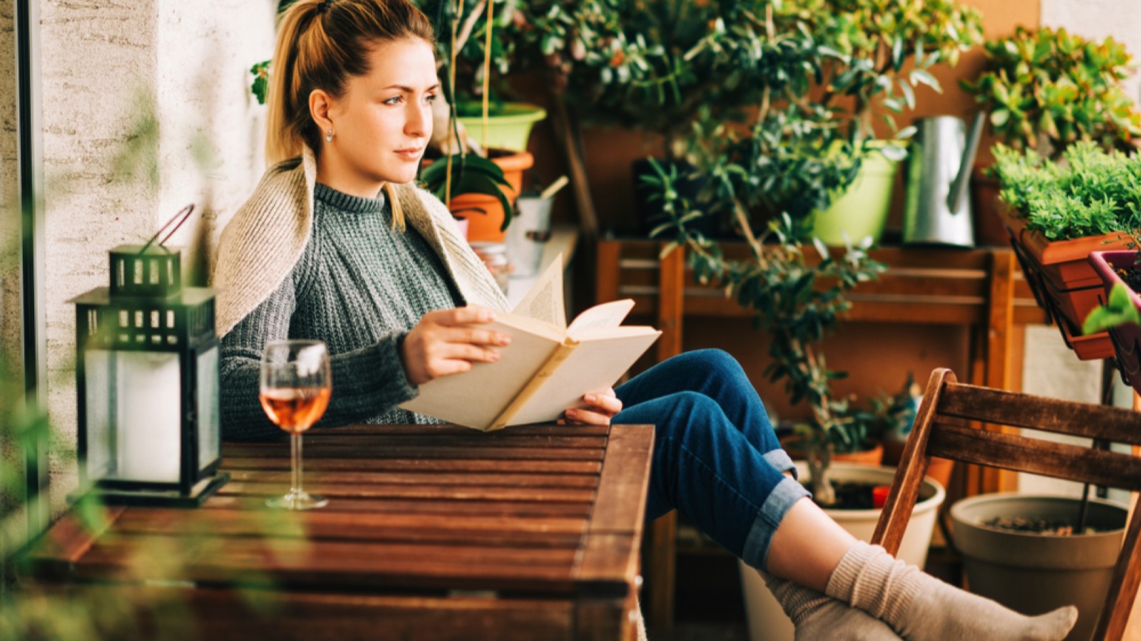 Beautiful woman in balcony reading novel