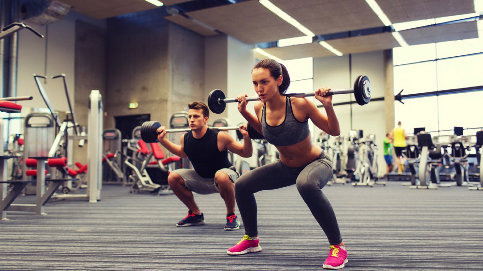 Woman and man working out at gym