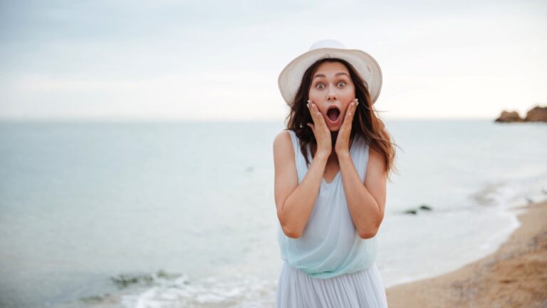 Young woman in beach shocked