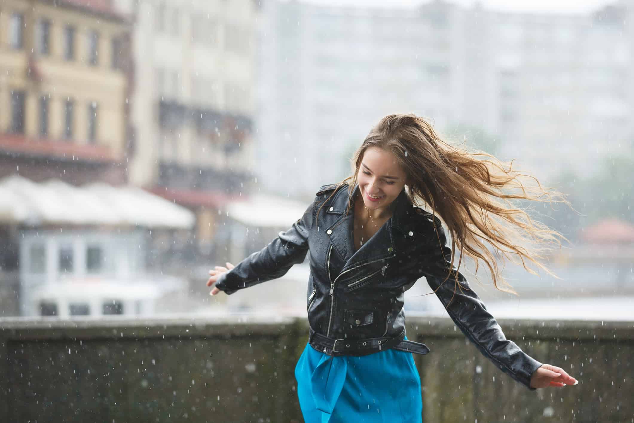 Young attractive girl is enjoying the summer rain